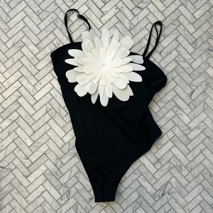 NWOT one piece bathing suit (w removable padding) with white flower detail.